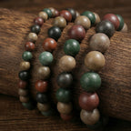 Four bead sizes of the Five Elements bracelet on weathered wood