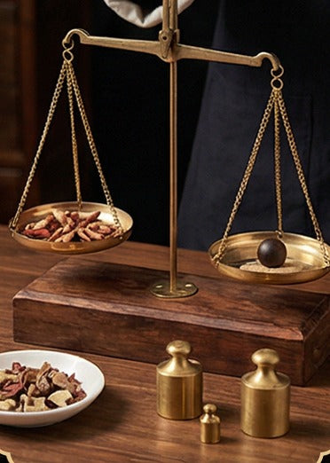 Materials weighed out on a brass balance scale
